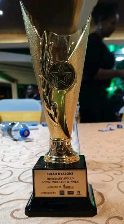 The honorary award trophy, engraved: Serah Nyaboke, Honorary Award, Music Industry Winner.